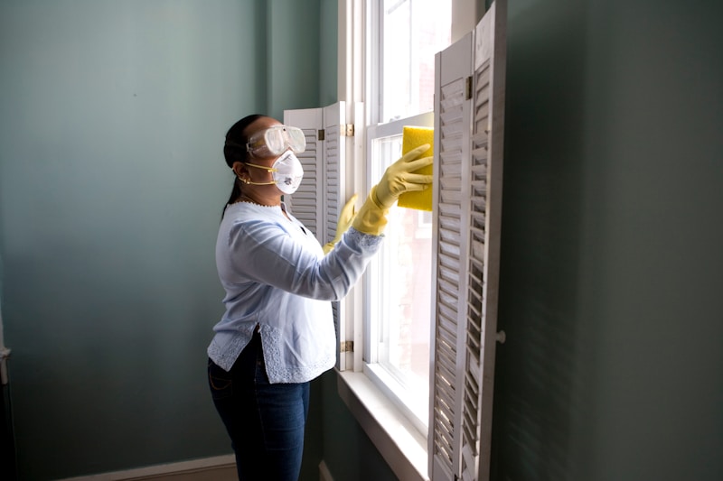 Close-up window cleaning with sponge on glass — detailed streak-free finish